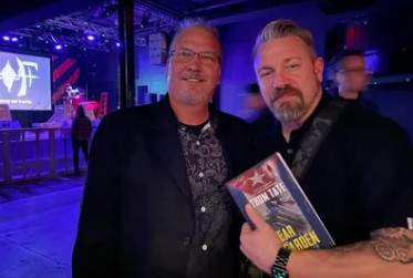 Thom Tate presenting Gerrit Thomas of Funker Vogt with a signed copy of Spear Garden